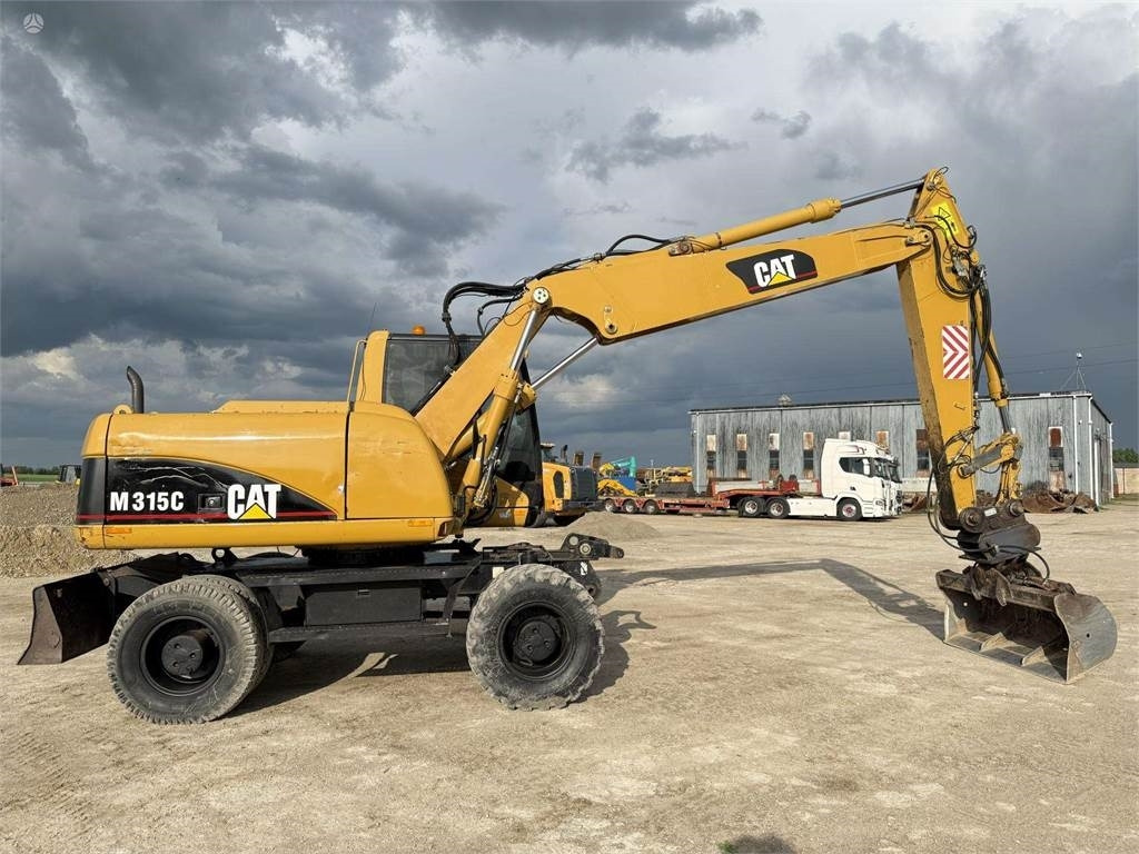 Excavator pe roţi CAT M315C: Foto 7