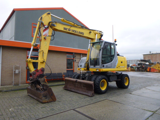 NEW HOLLAND MH PLUS - Excavator pe roţi: Foto 1 NEW HOLLAND MH PLUS - Excavator pe roţi: Foto 1