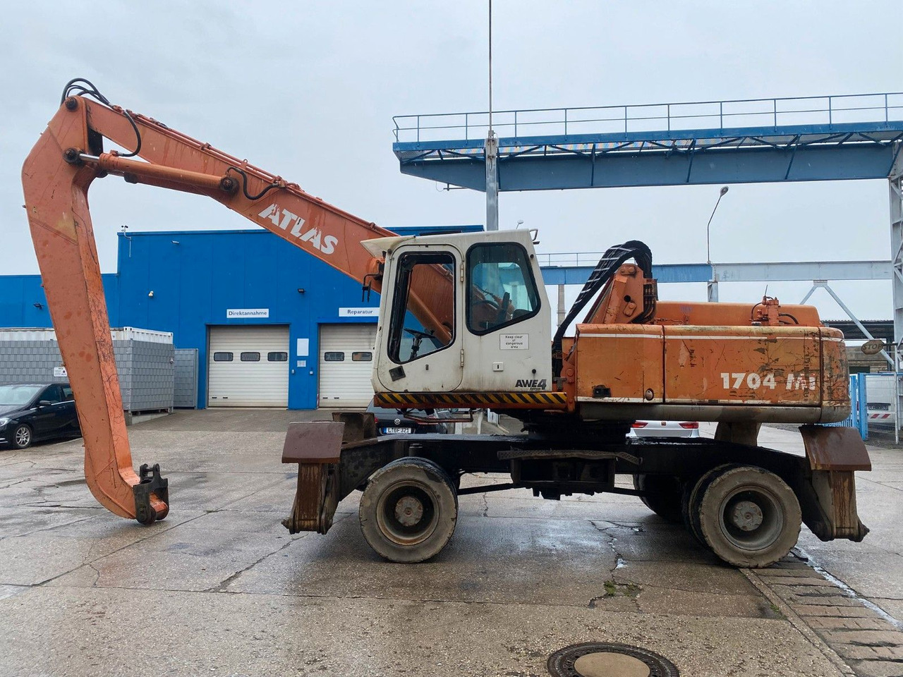 Atlas 1704 MI mit Greifer Umschlagbagger Lang - Excavator pe roţi: Foto 1 Atlas 1704 MI mit Greifer Umschlagbagger Lang - Excavator pe roţi: Foto 1