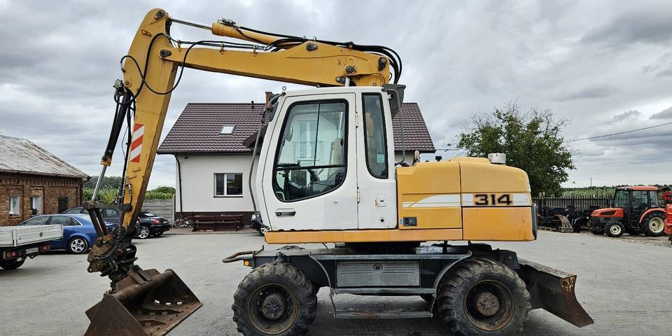 Koparka kołowa Liebherr A314 Litronic 9350 h+ 5 łyżek kołówka - Excavator pe roţi: Foto 1 Koparka kołowa Liebherr A314 Litronic 9350 h+ 5 łyżek kołówka - Excavator pe roţi: Foto 1